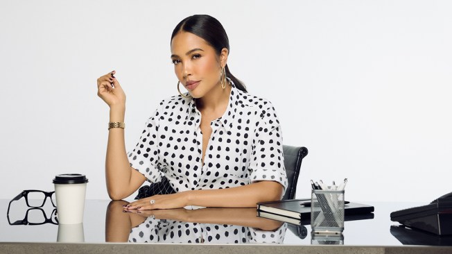 emma grede sitting at a desk wearing a polka dot shirt